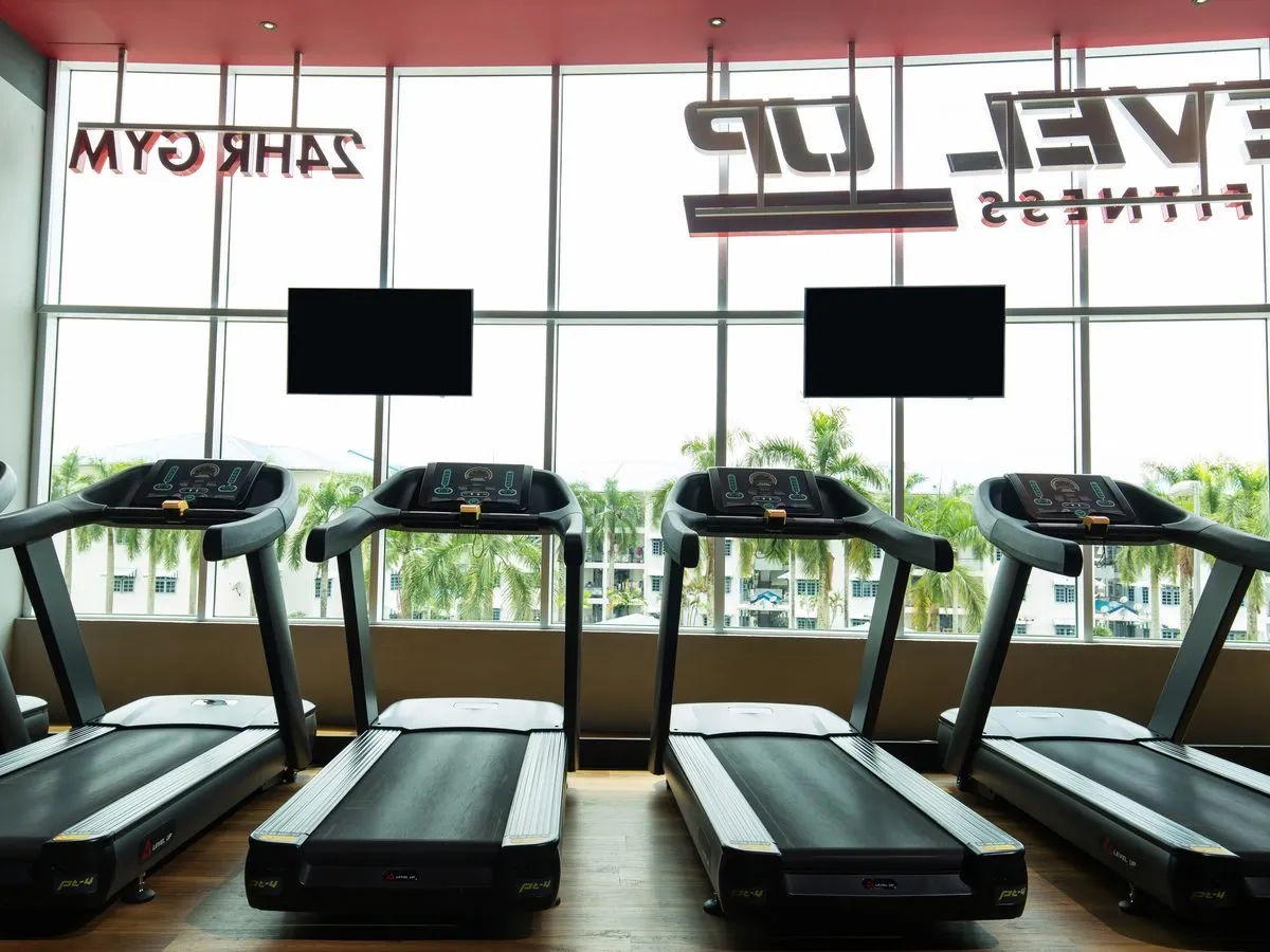 Treadmills by the window at Level Up Fitness AEON Mall